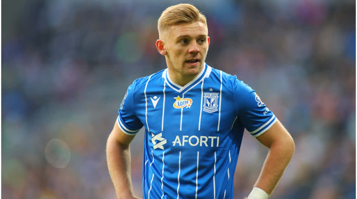 Soccer_ Player_in_ Blue_ Striped_ Kit Background
