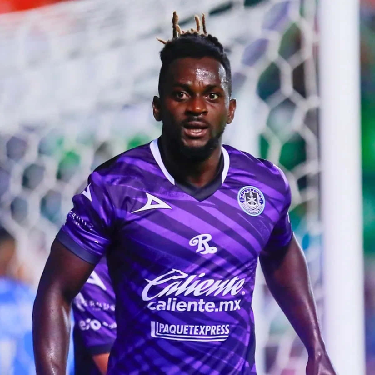 Soccer_ Player_in_ Purple_ Kit Background