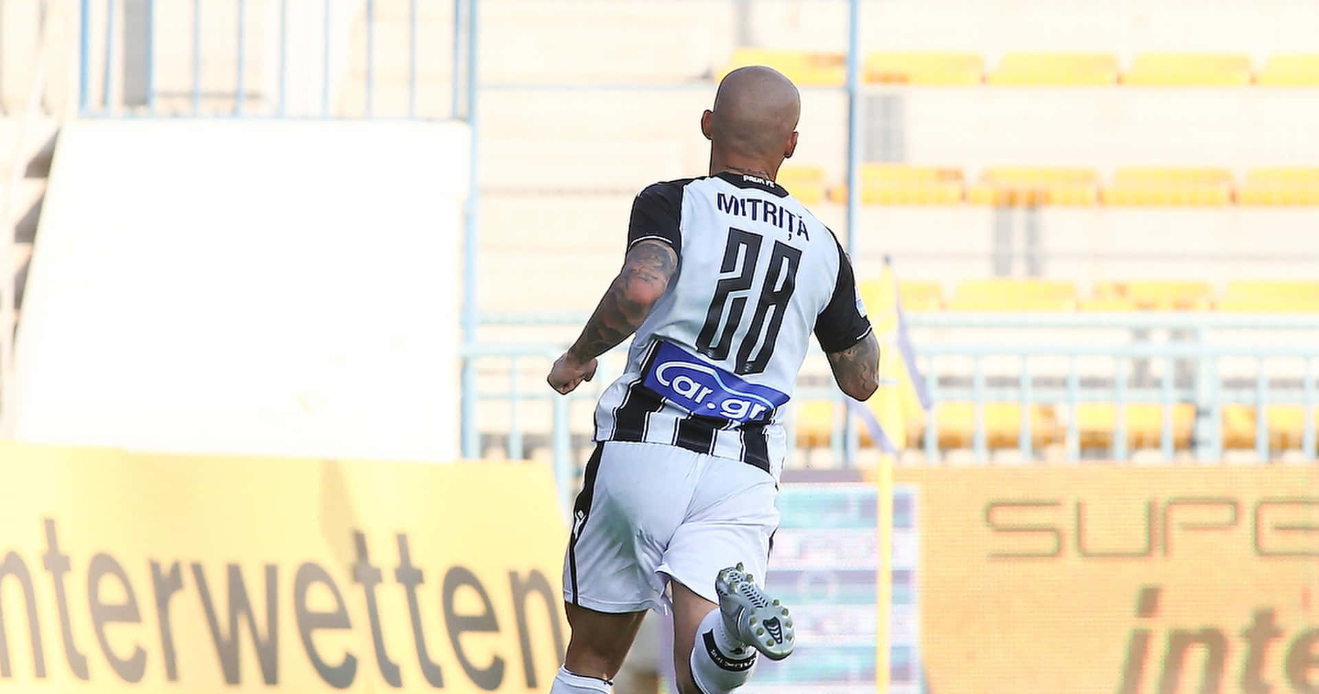 Soccer Player Mitrita Running On Field Background