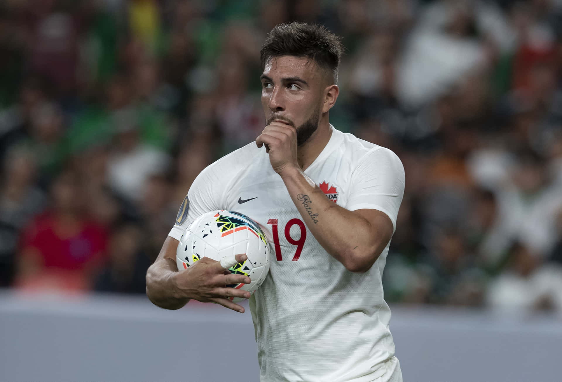 Soccer Player Thoughtful Moment During Match Background