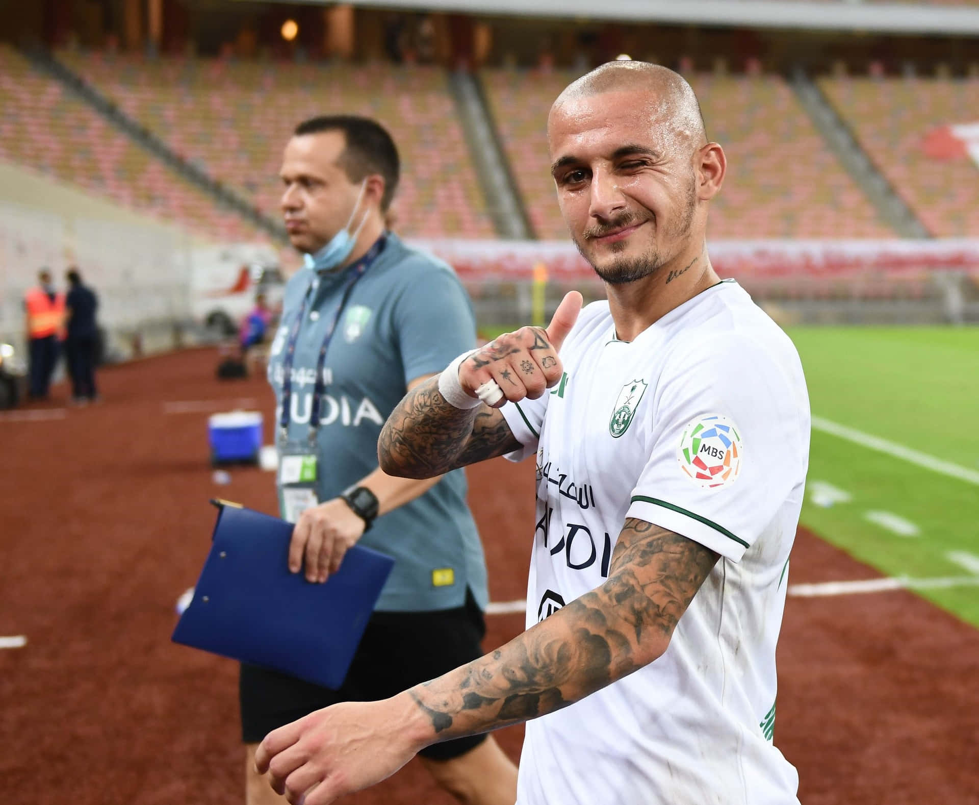 Soccer Player Thumbs Upat Stadium Background