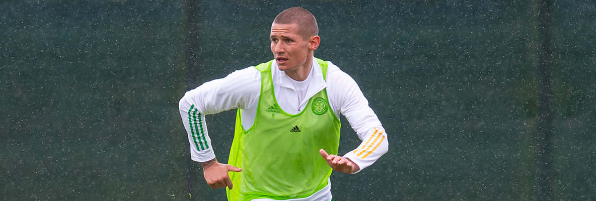 Soccer Player Trainingin Rain Background
