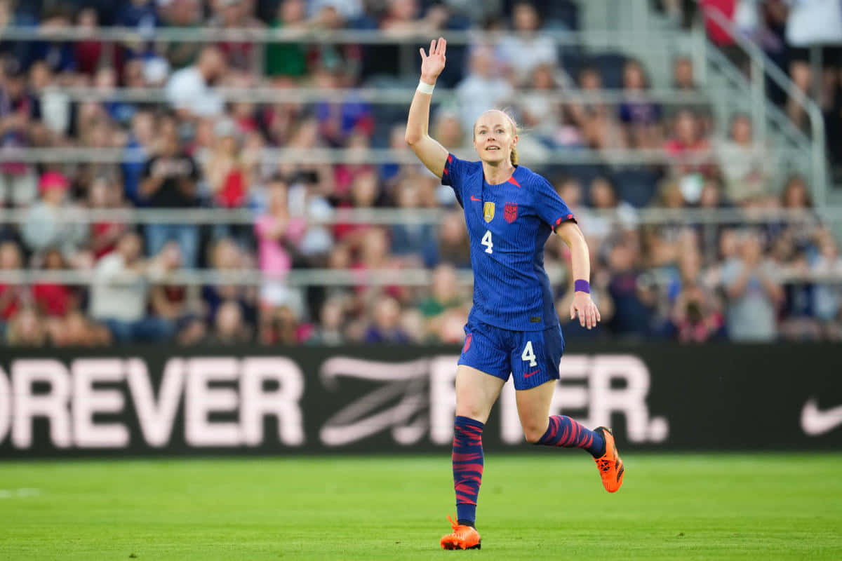 Soccer Player Waving On Field Background