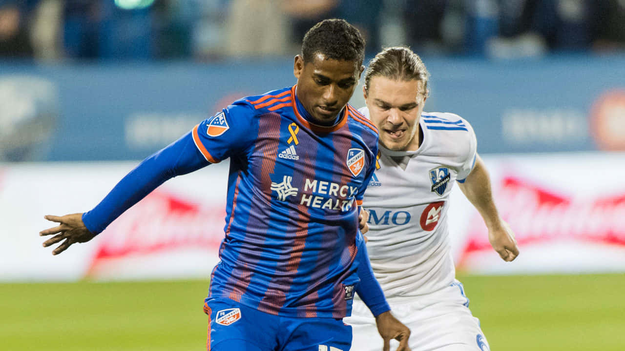 Soccer Players Competing During Match Background