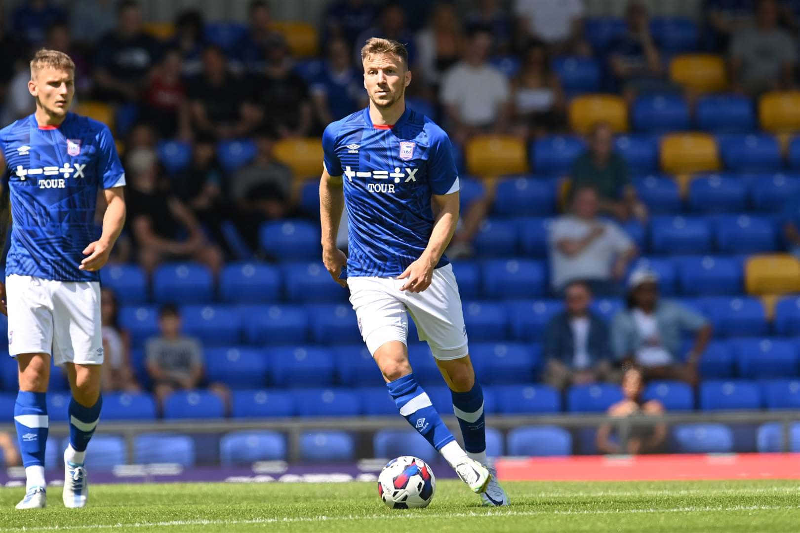 Soccer Playersin Blue Kit During Match Background