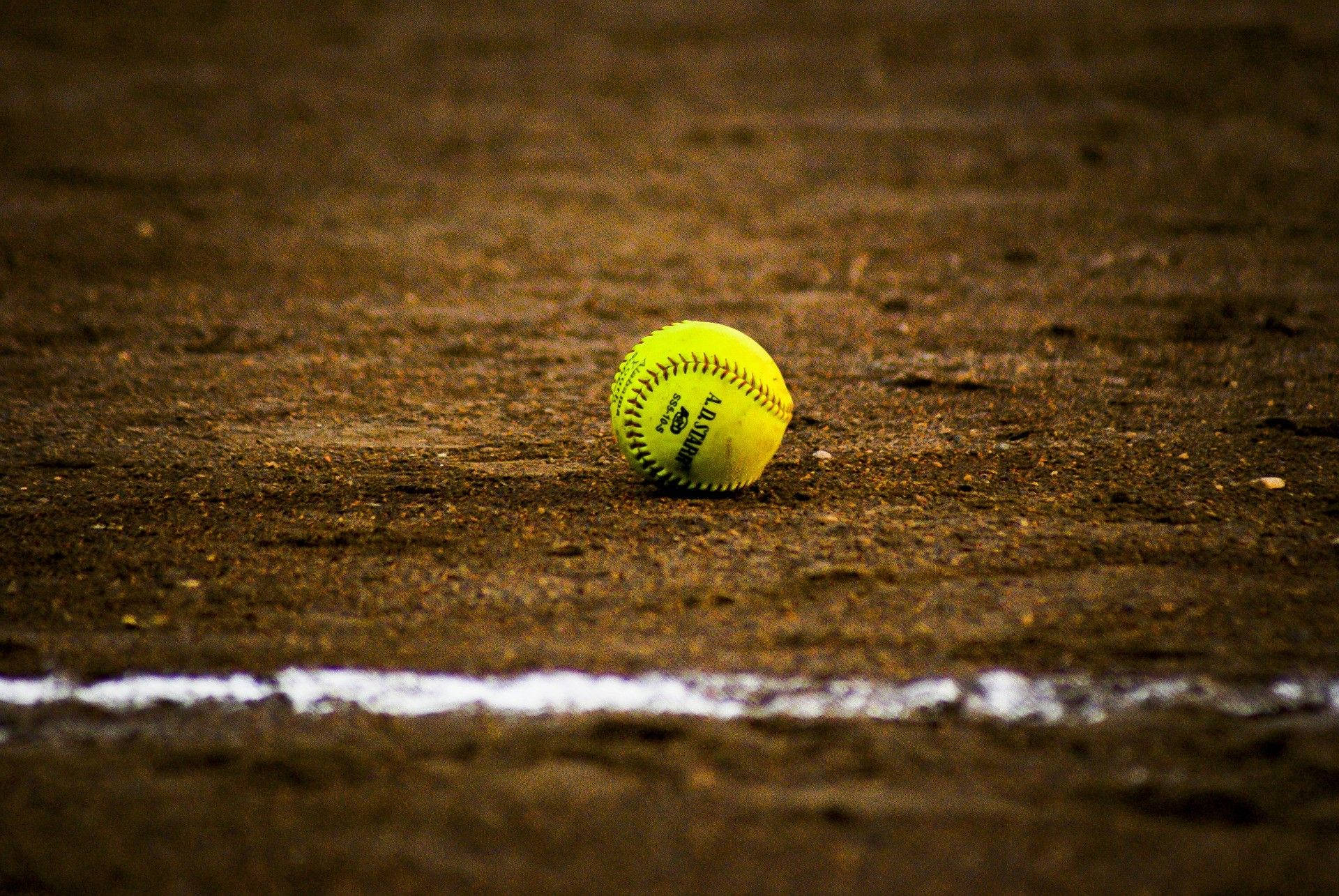 Softball In The Middle Of Field Background