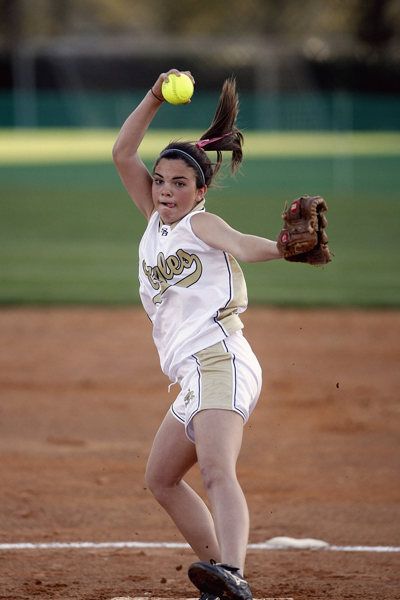 Softball Pitcher Throwing The Ball Background