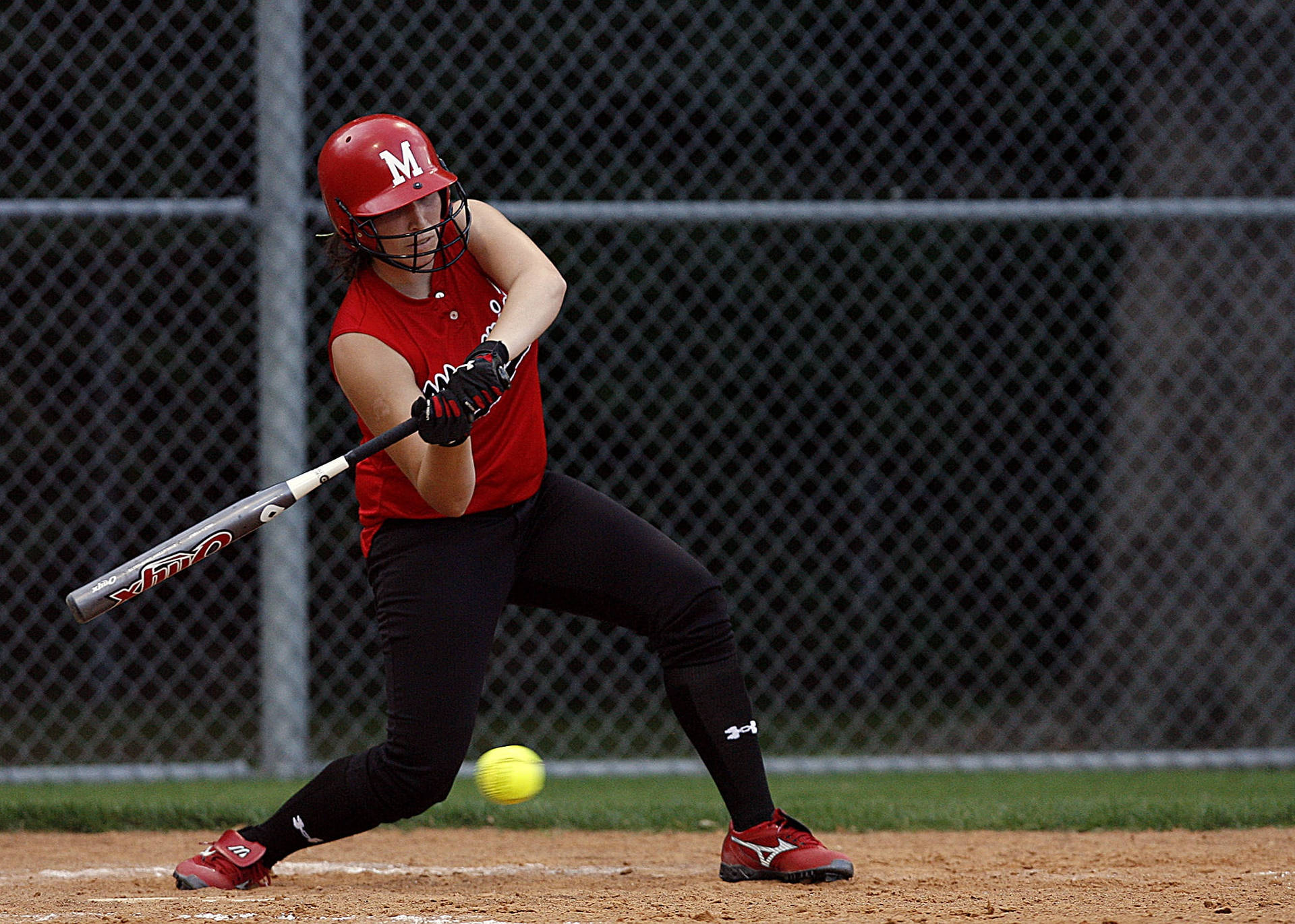 Softball Player Swinging Bat To Ball