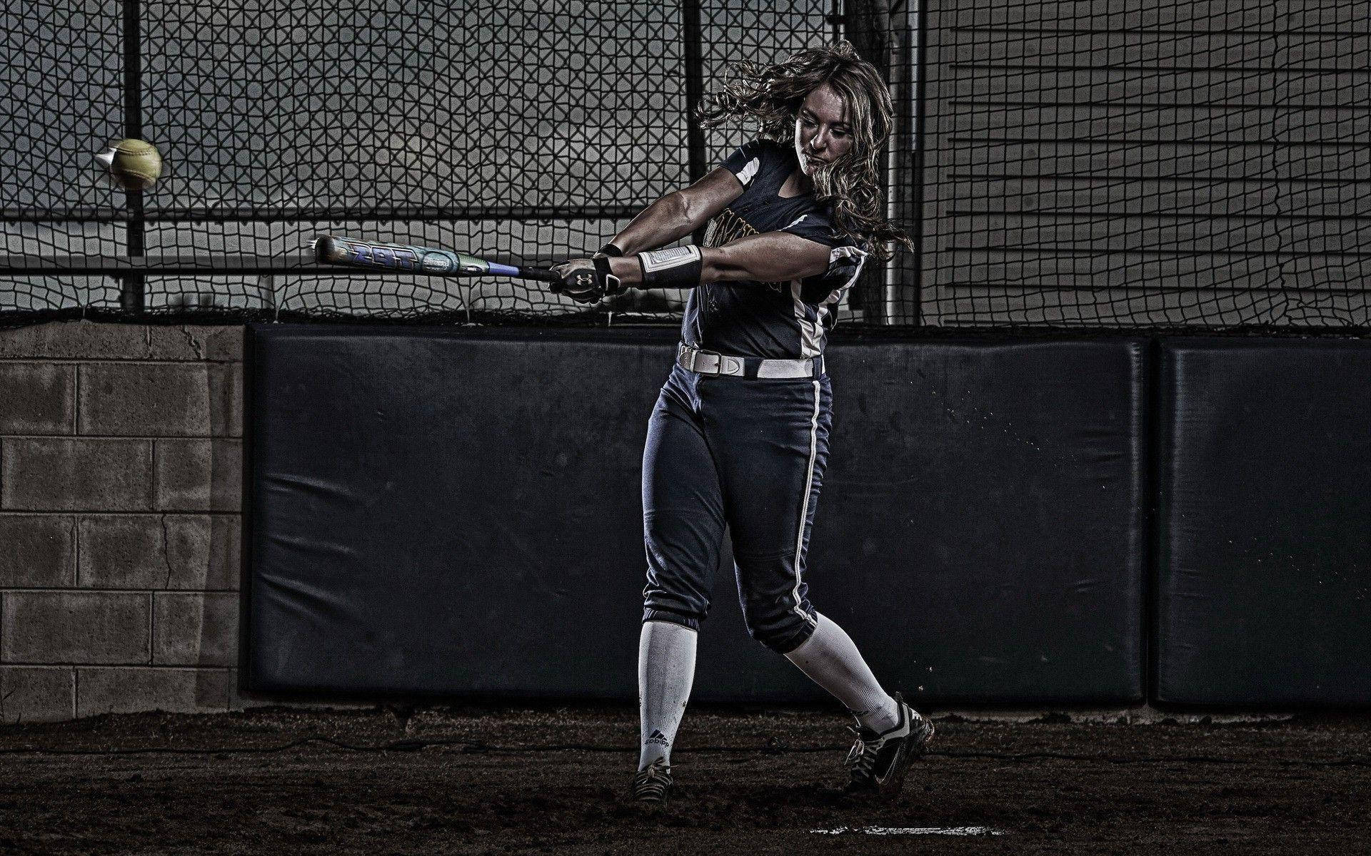 Softball Player Swinging The Bat Background