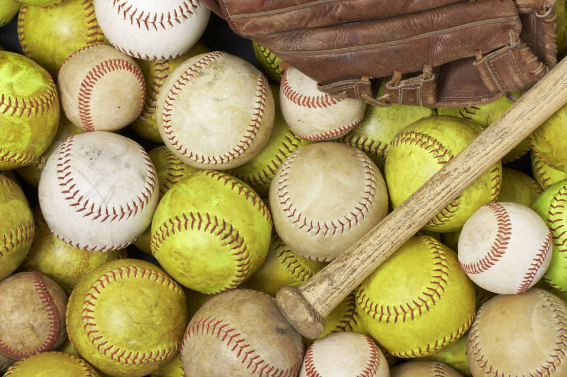 Softball Stock Pile With Bat Background