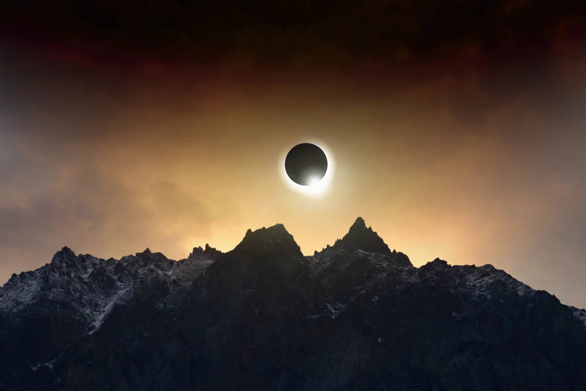 Solar Eclipse On Cloudy Mountaintop Background