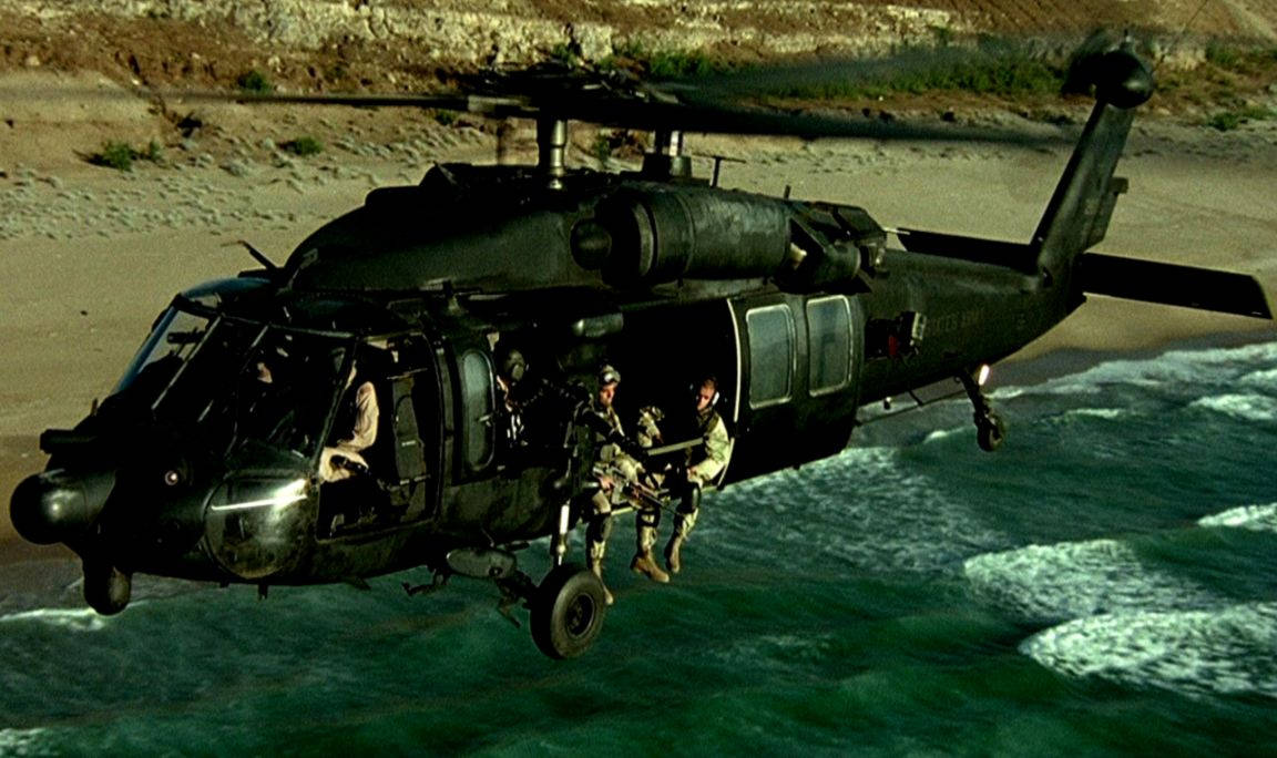 Soldiers On Black Hawk Helicopter Edge