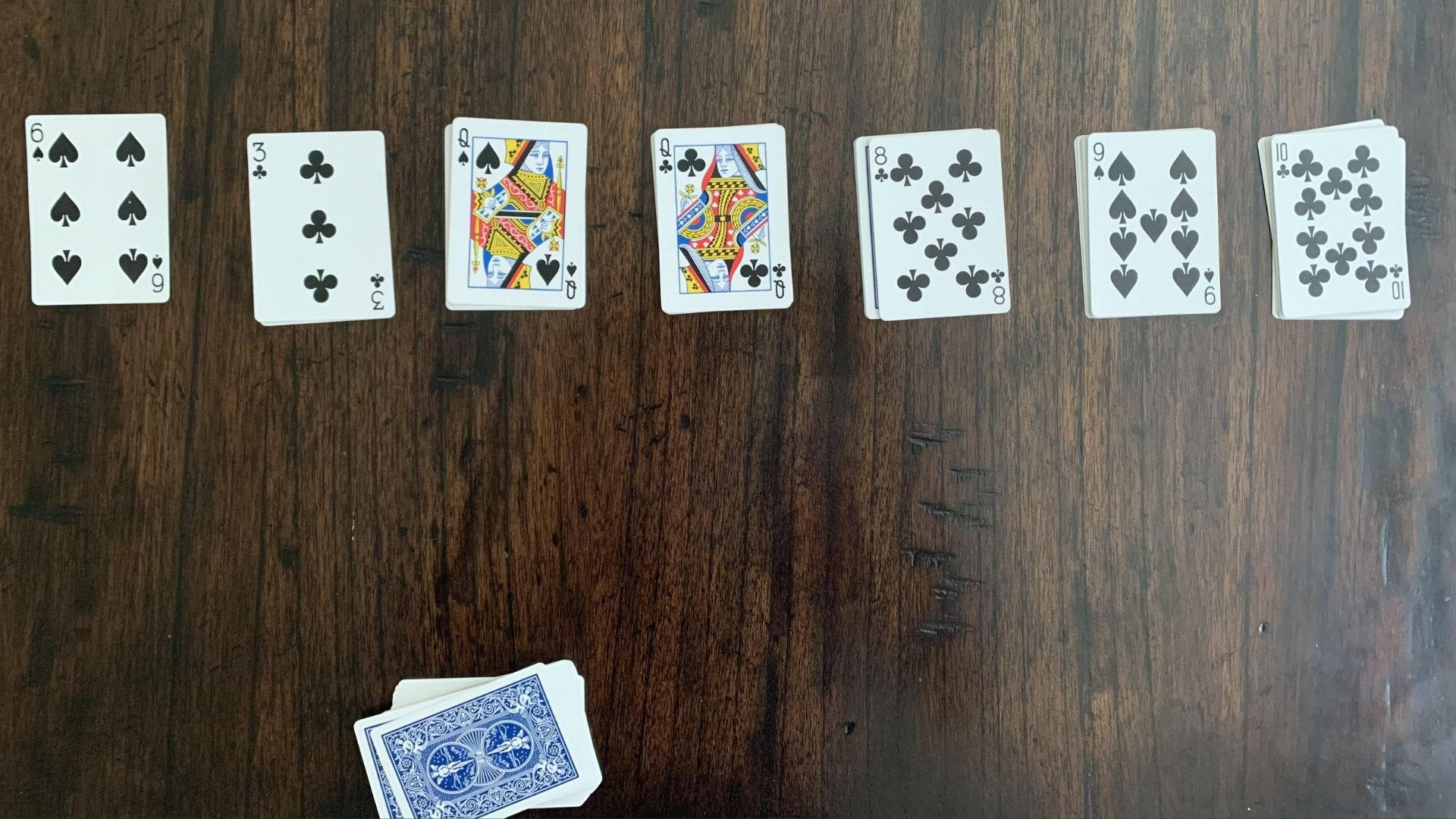 Solitaire On A Wooden Table Background