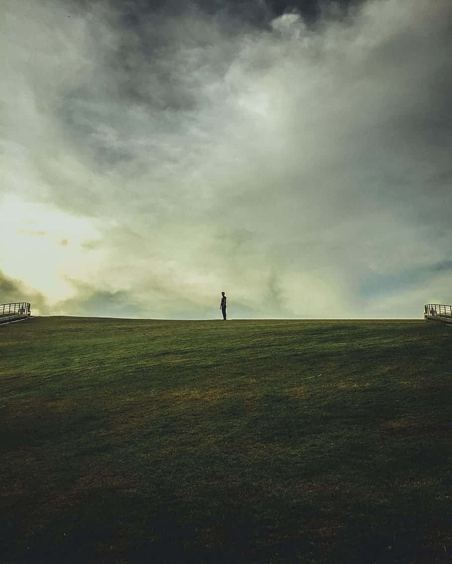 Solitary Man In Fields Background
