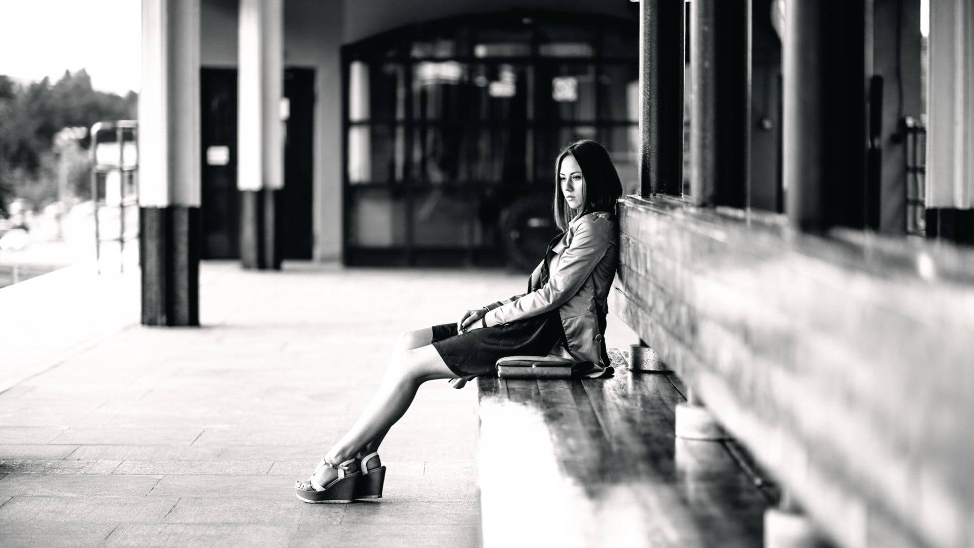 Solitary Moment - A Woman Sitting Alone On A Bench Background