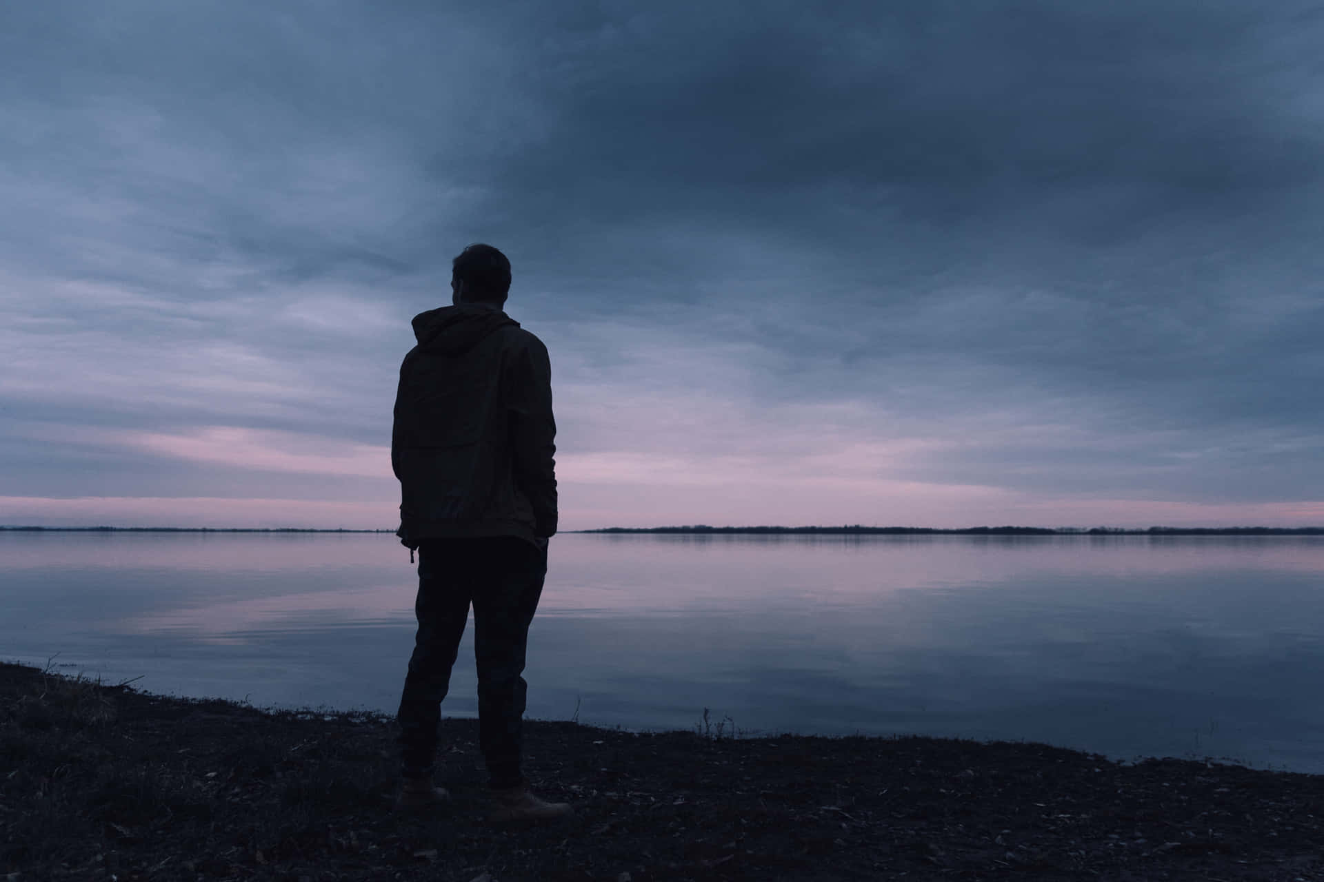 Solitary Silhouette Facing Sea Background