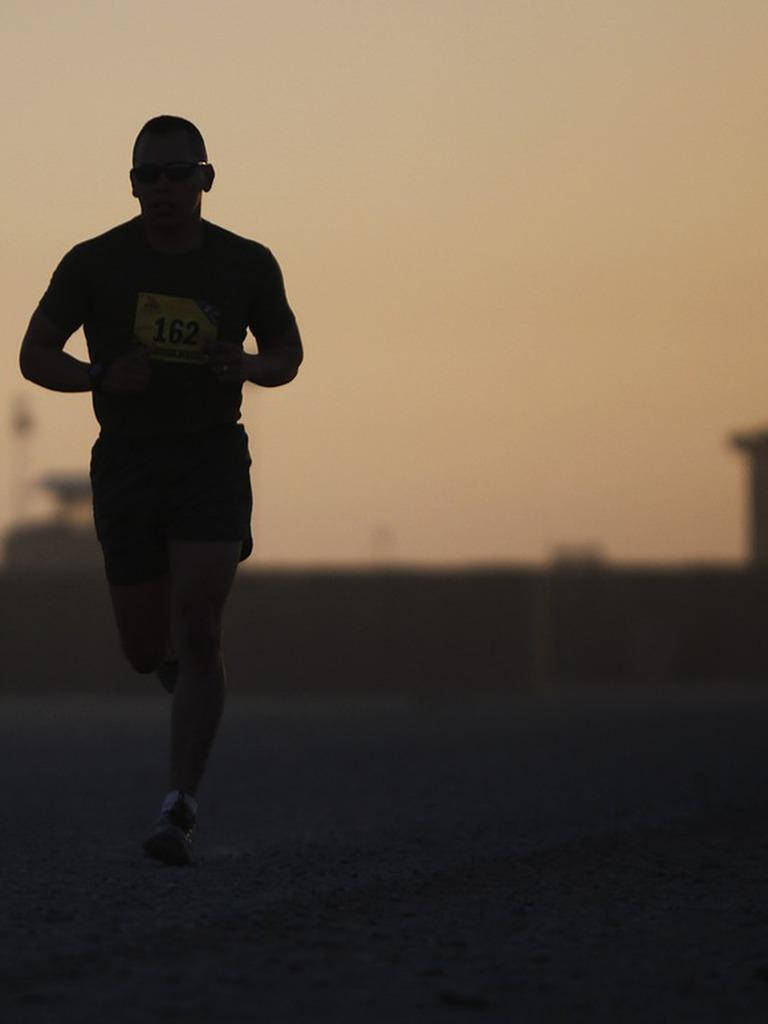 Solo Man Athlete In Marathon Background