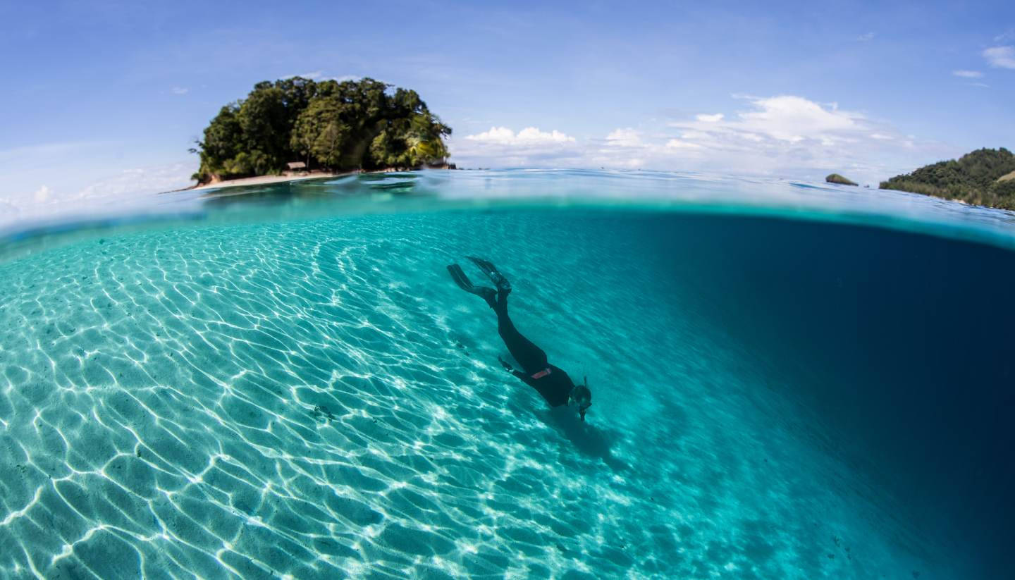 Solomon Islands With Person Swimming Background