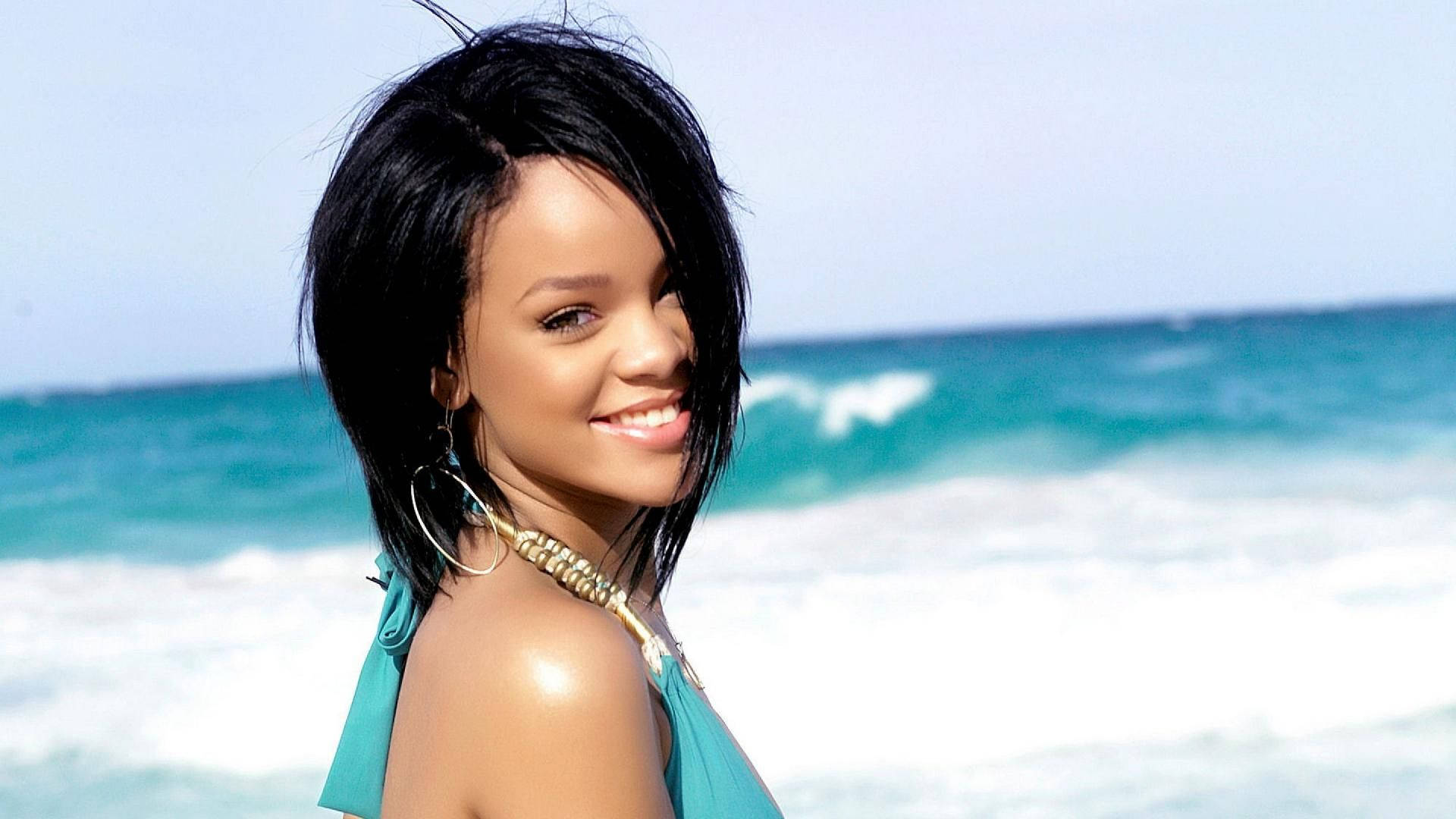 Songstress Rihanna Strikes A Pose In A Stunning Beach Photo Shoot Background