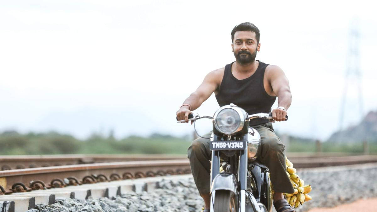 Soorarai Pottru Suriya On Motorcycle Near Tracks