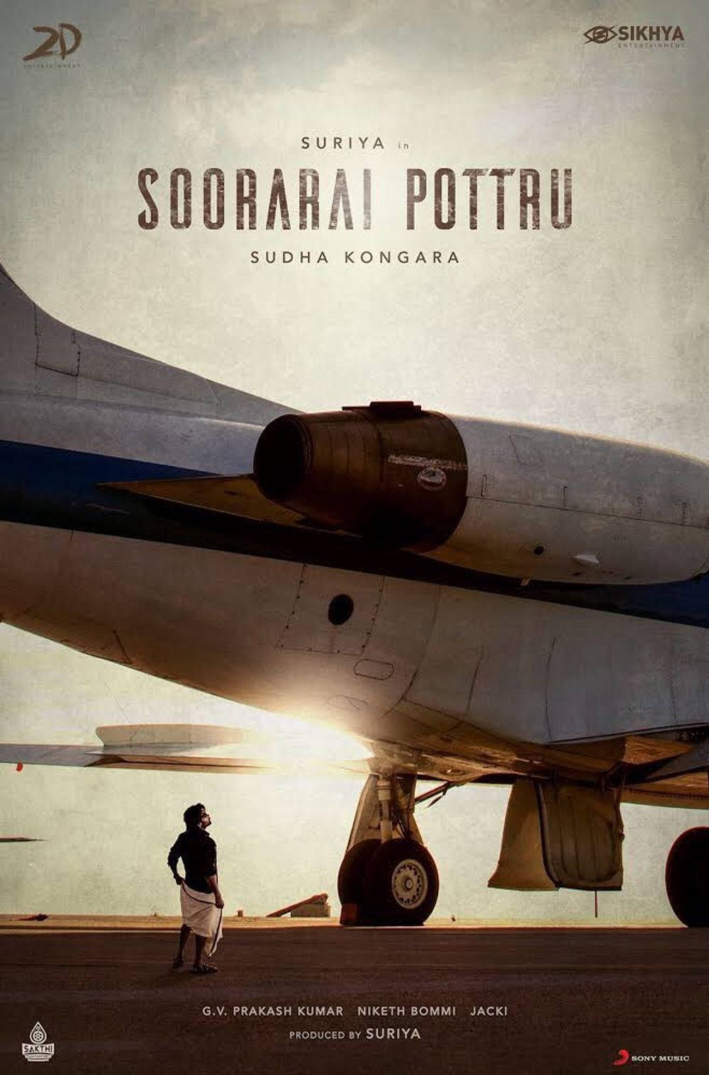 Soorarai Pottru - Suriya Standing Under An Airplane Background