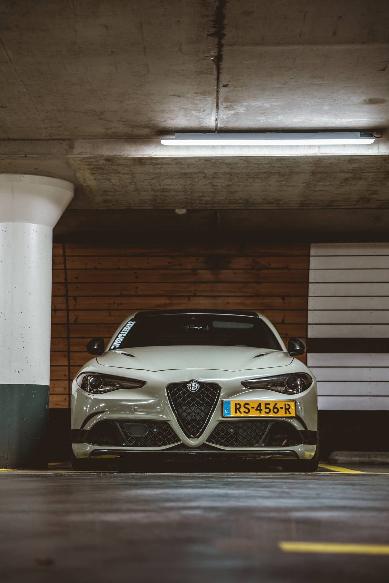 Sophisticated Alfa Romeo In A Parking Lot Background