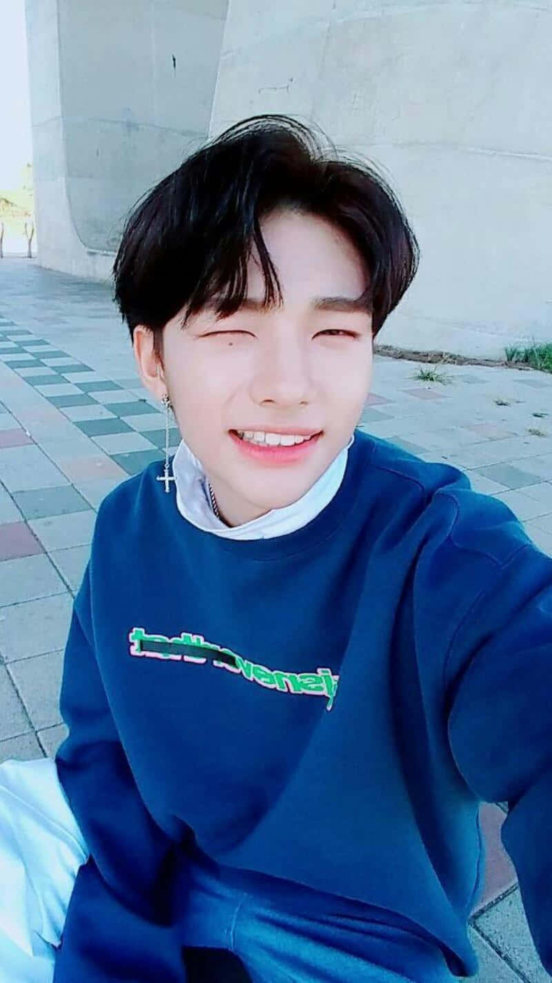 South Korean Rapper Hyunjin Winking Selfie Background