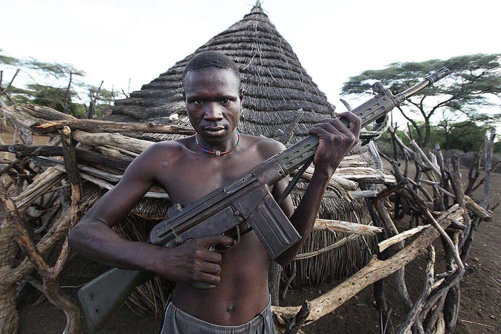 South Sudan Man Holding Assault Rifle Background