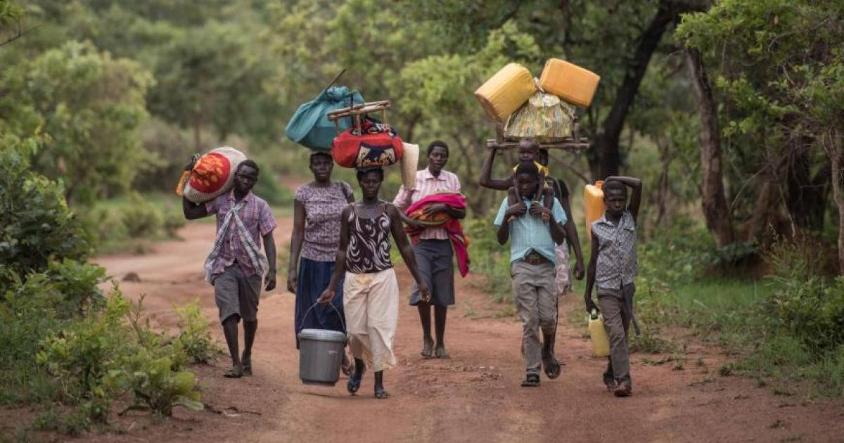 South Sudan People Carrying Down Road Background