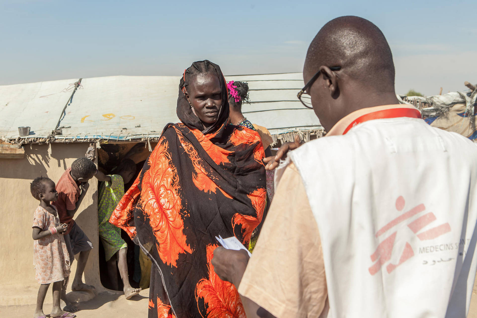 South Sudanese Woman In Vibrant Orange Dress Background