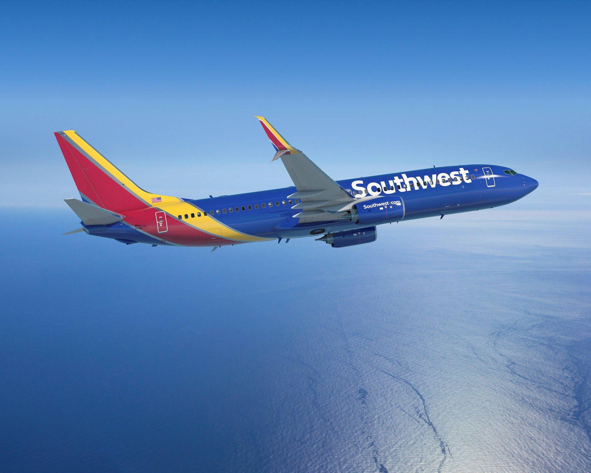 Southwest Airlines Airplane Over Ocean Background