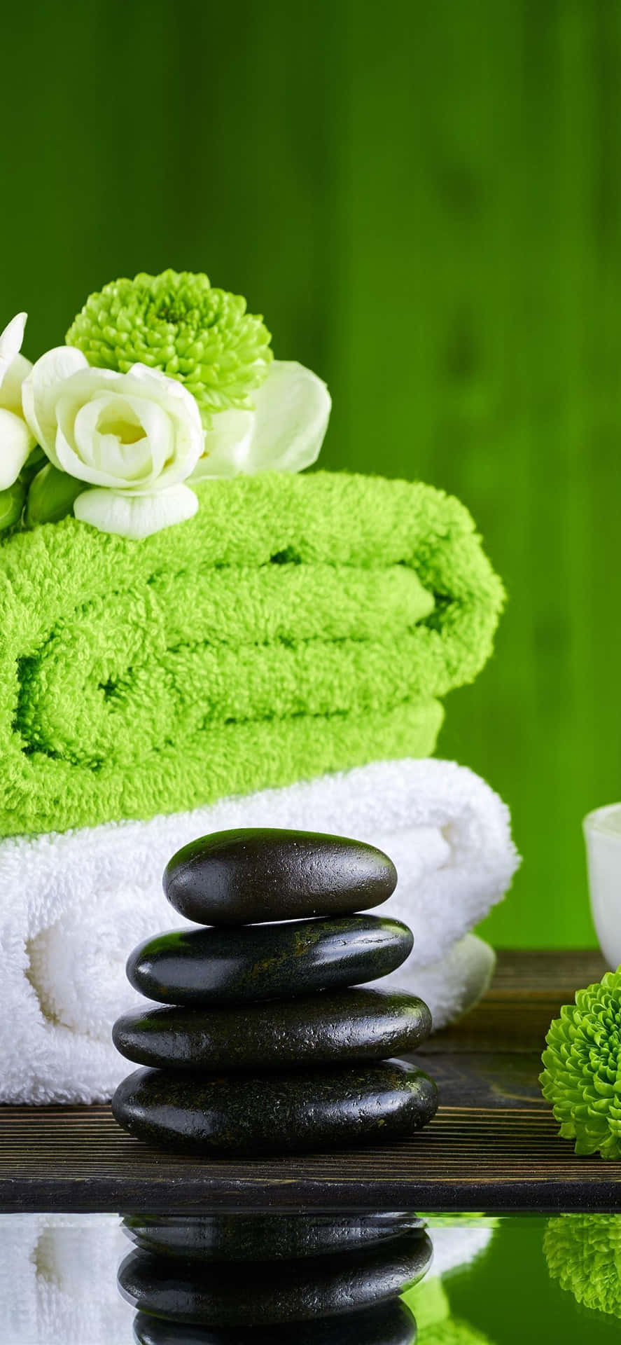 Spa Essentials Green Towelsand Stones Background
