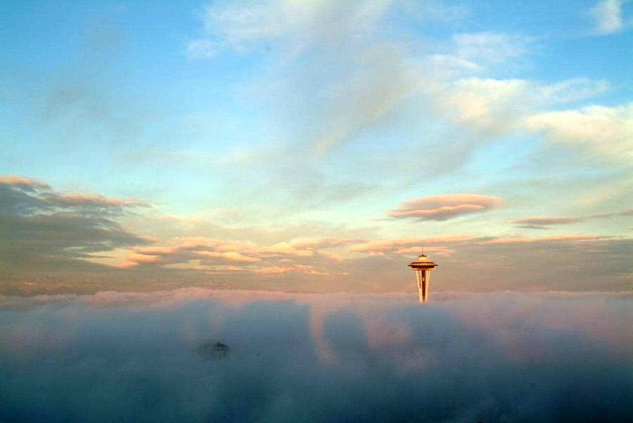 Space Needle Above Clouds Background