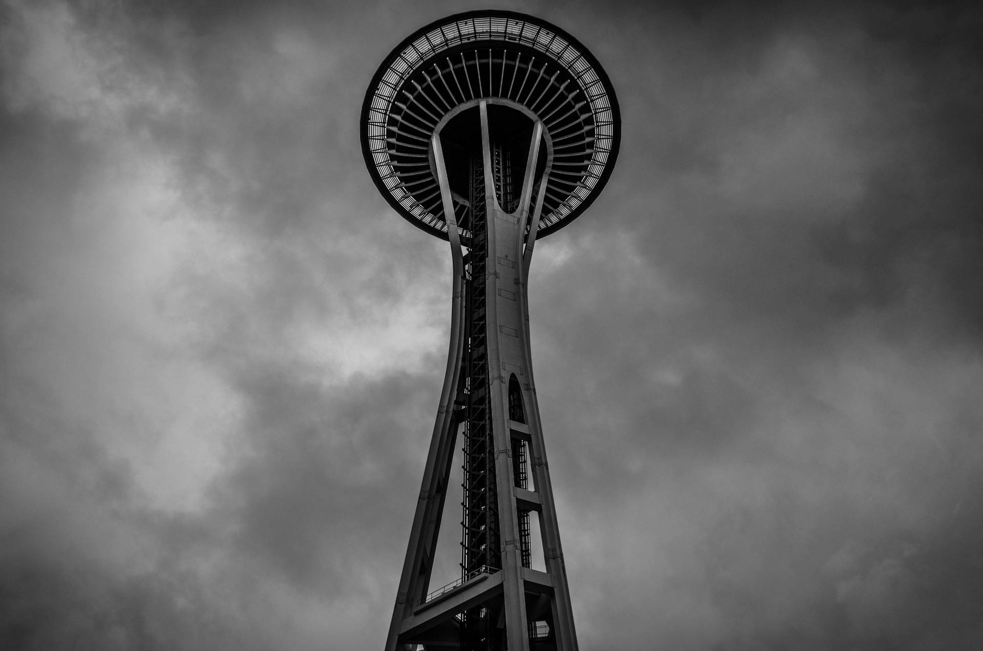 Space Needle Under Seattle Rain Clouds Background