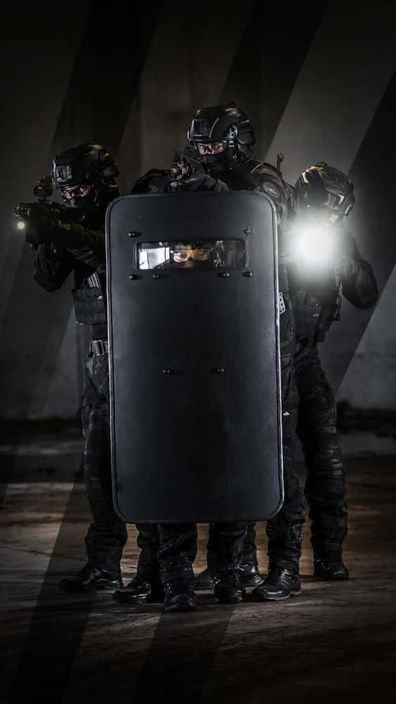 Specialized Trained Swat Police Units In Tactical Gear Prepared To Respond To Any Situation. Background