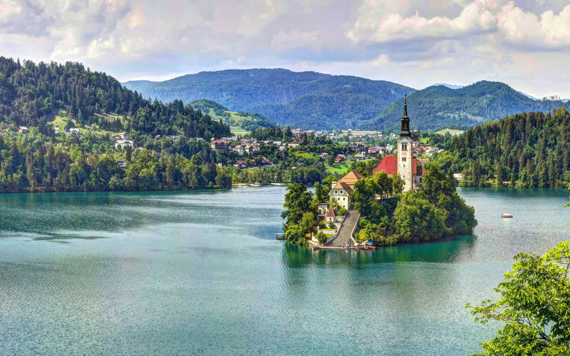 Spectacular Lake Bled Surrounded By Majestic Mountains Background