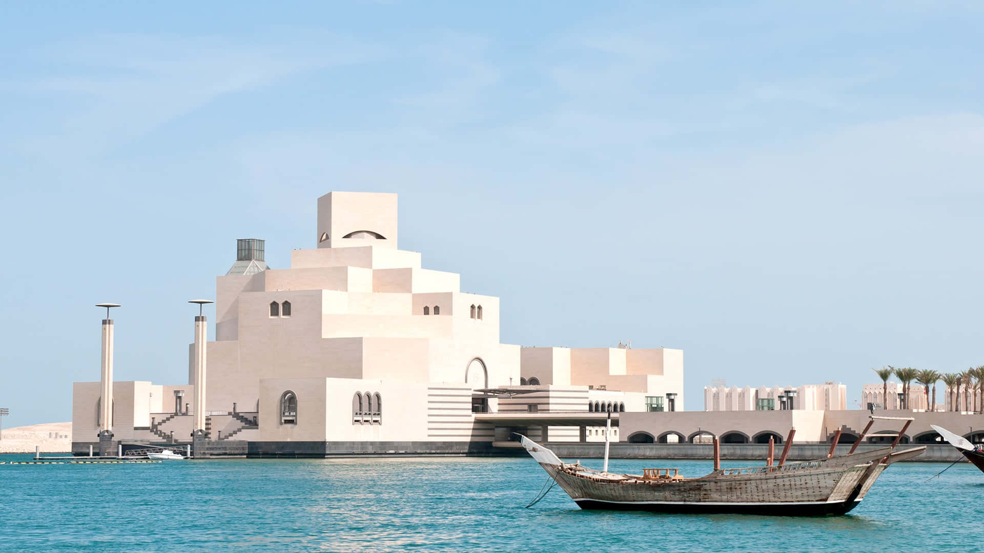 Spectacular View Of Boats Approaching The Museum Of Islamic Art Background