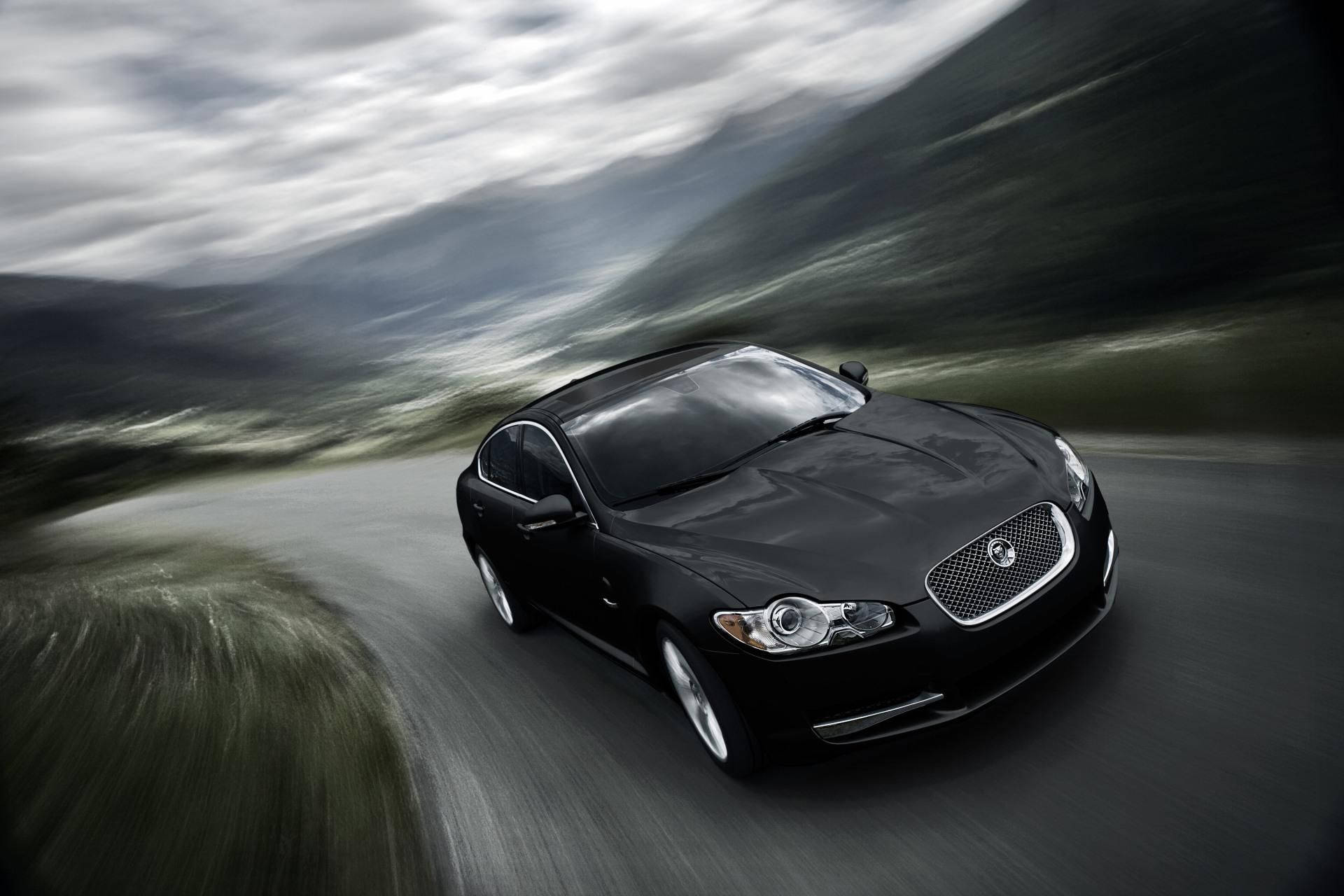 Speed And Style Combine In This Sleek Black Jaguar Car. Background