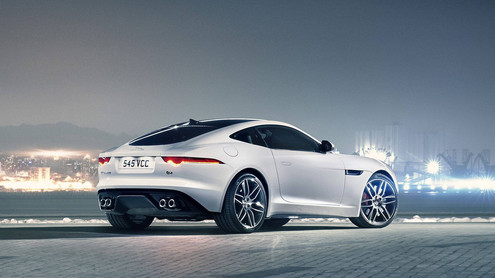 Speed Into The Night With This Sleek, Silver Jaguar Car Background