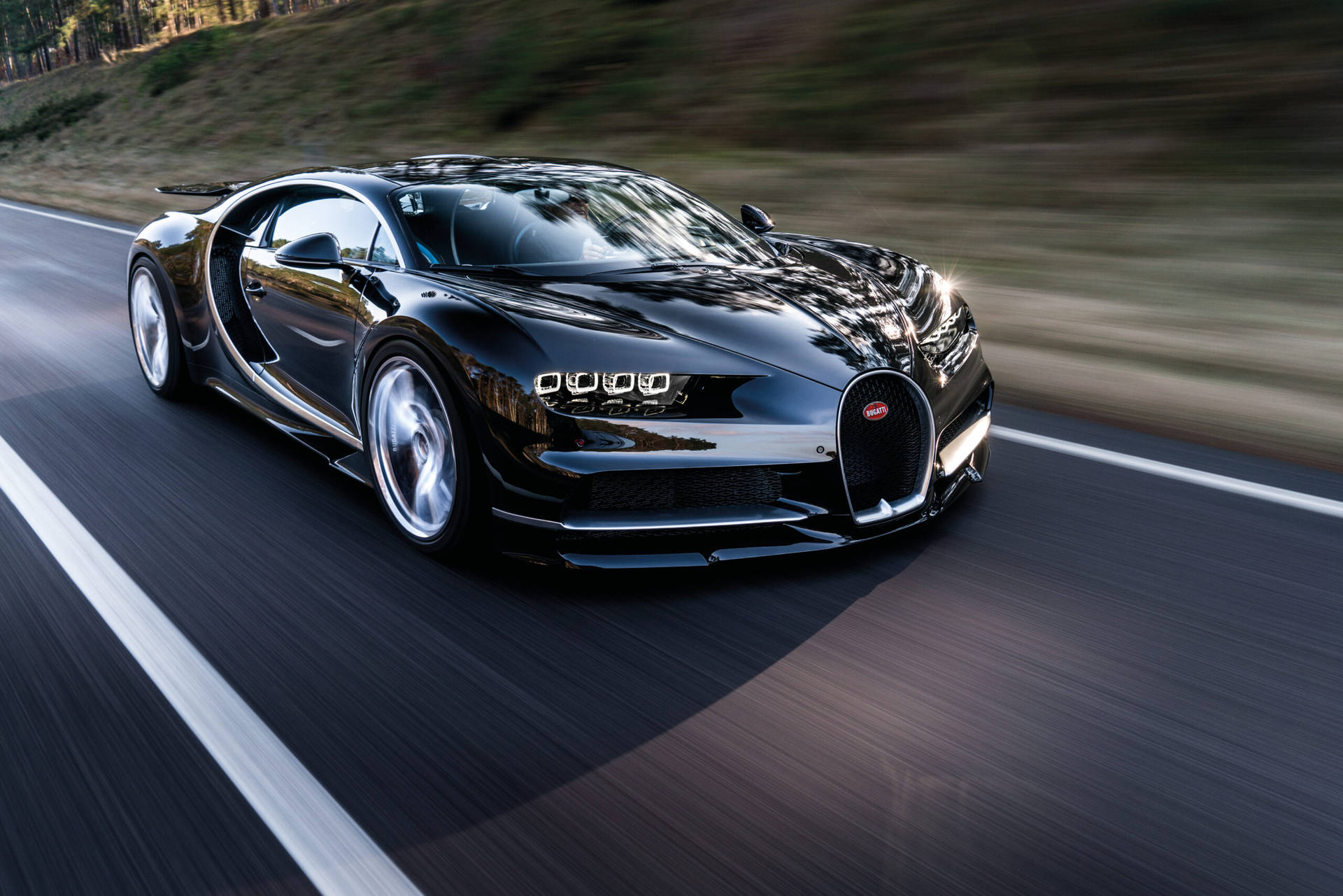 Speeding Cool Bugatti On Road Background