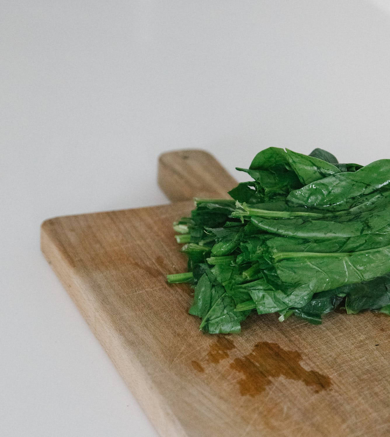 Spinach On Wooden Board