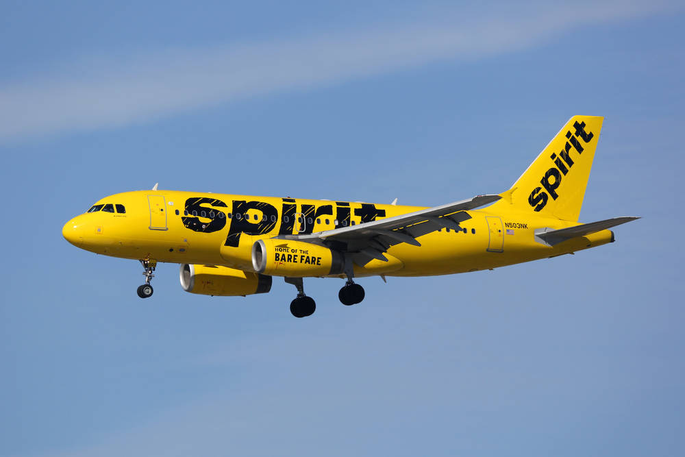 Spirit Airlines Yellow Aircraft In Flight Background