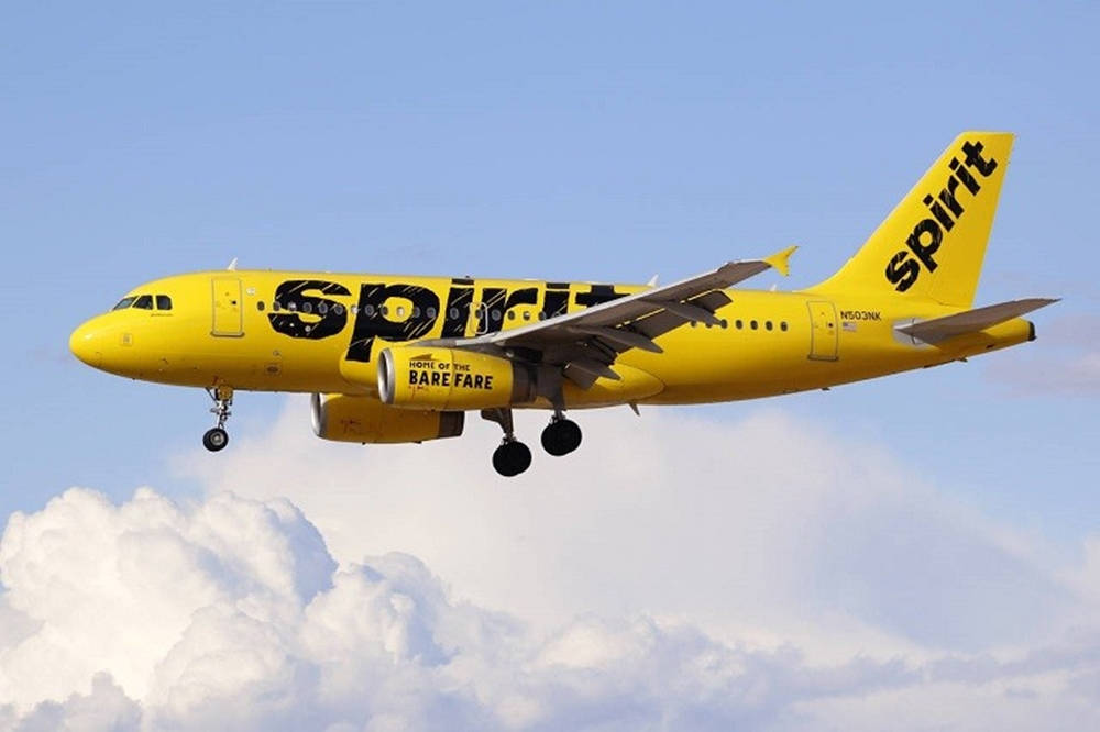 Spirit Airlines Yellow Plane On Clouds