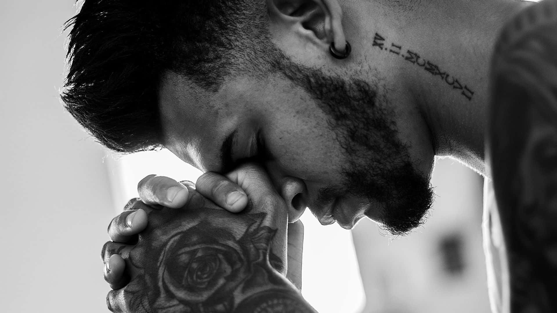 Spiritual Ink - Closeup Shot Of A Man With Hand Tattoo Meditating Or Praying. Background