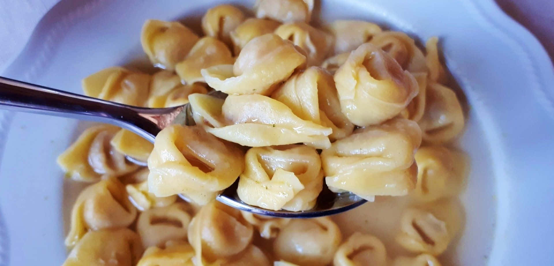 Spoonful Of Tortellini In Brodo Background