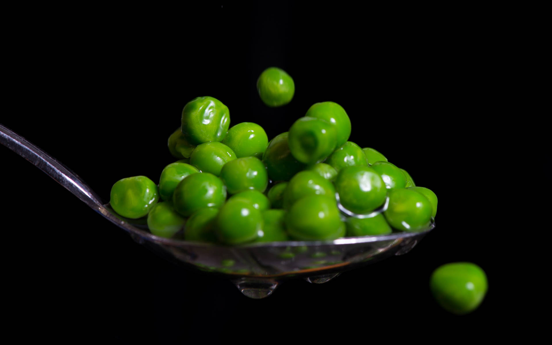 Spoonful Of Vegetable Green Peas Background