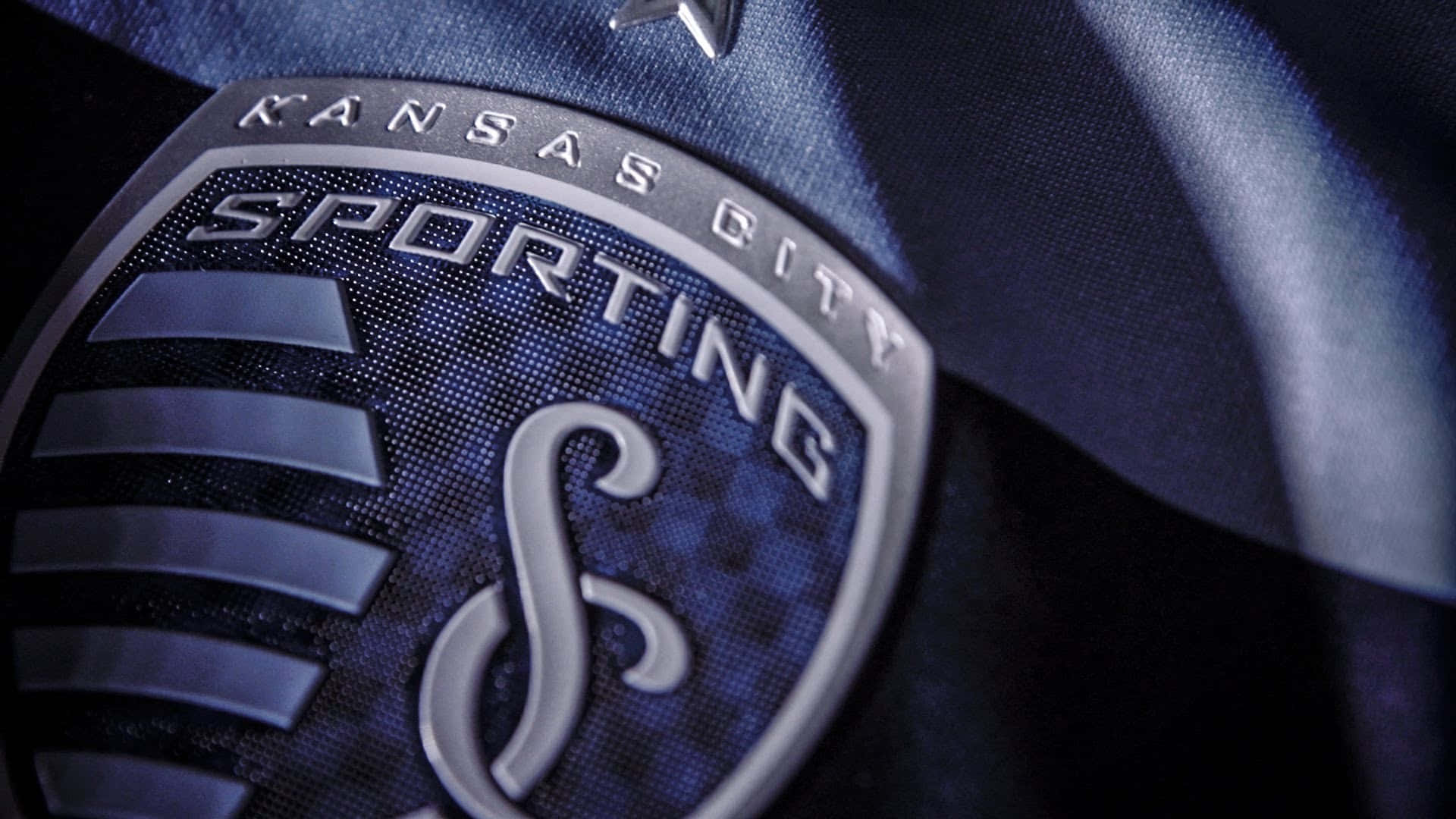 Sporting Kansas City Logo On Blue Jersey Background