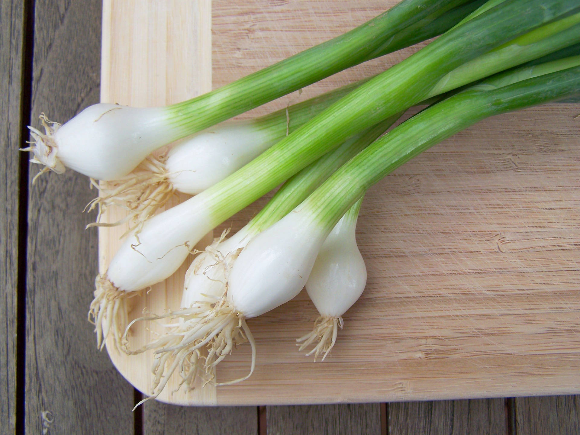 Spring Onions On Wooden Chopping Board