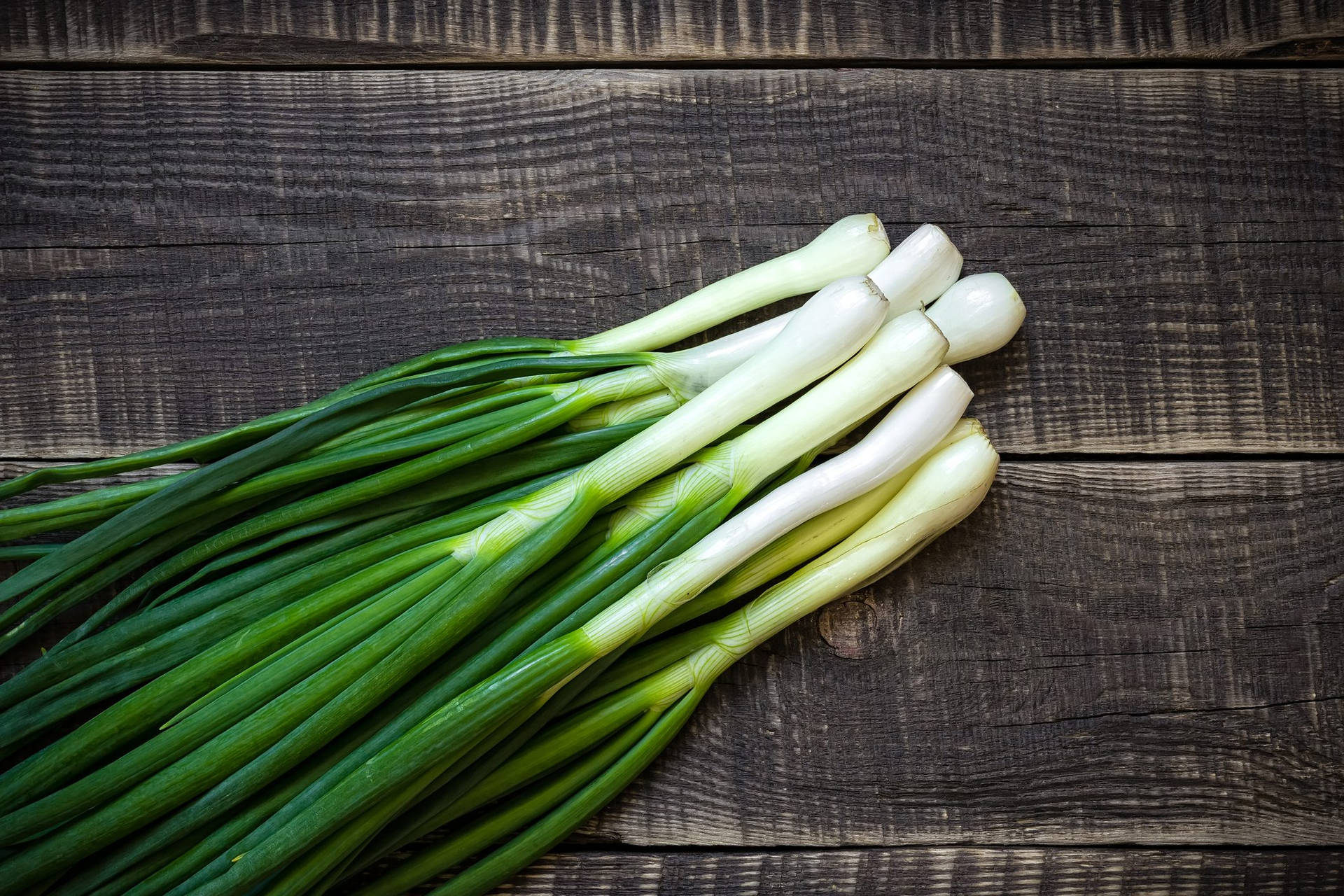 Spring Onions On Wooden Surface