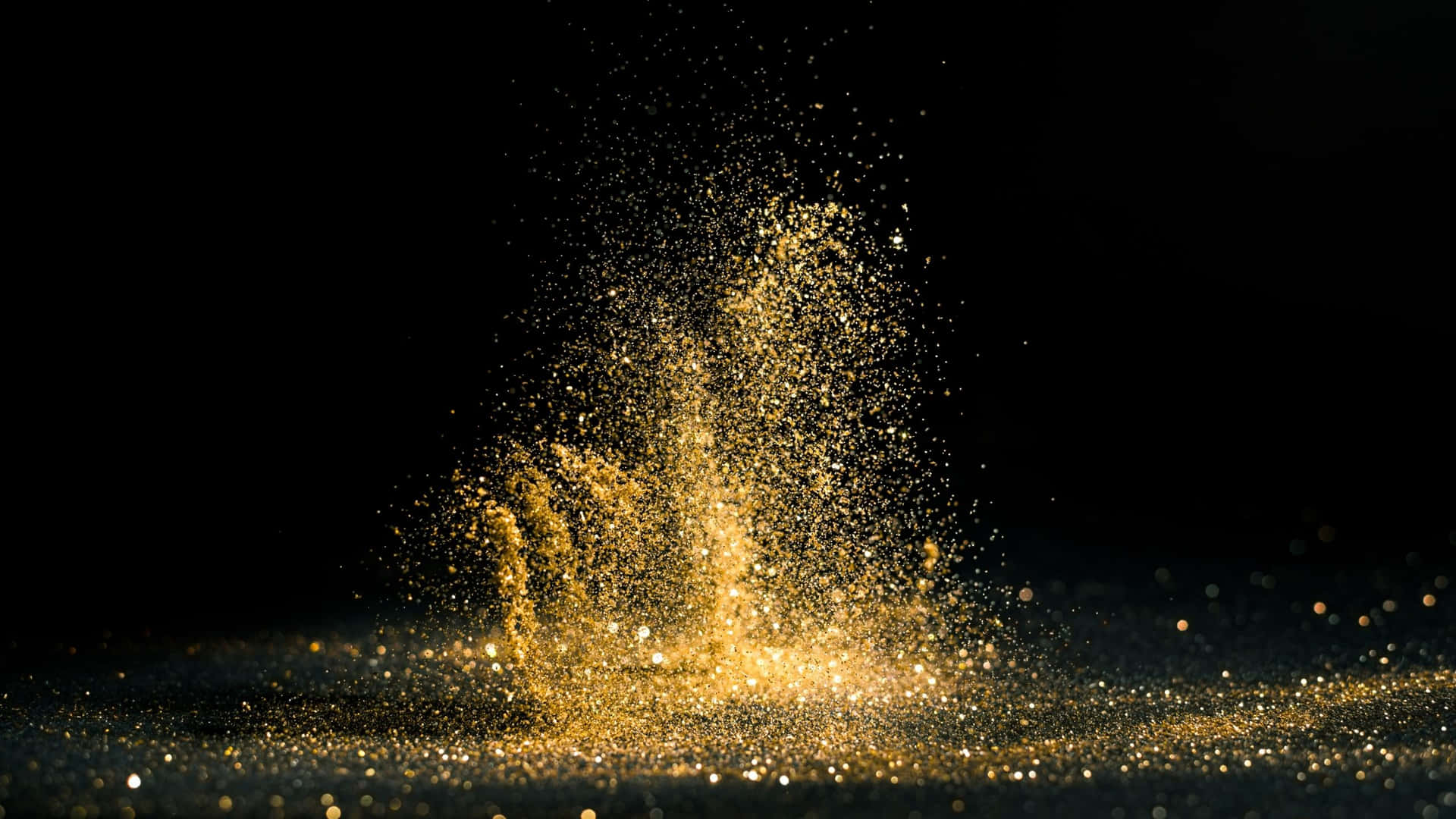 Sprinkled Black And Gold Glitter Background